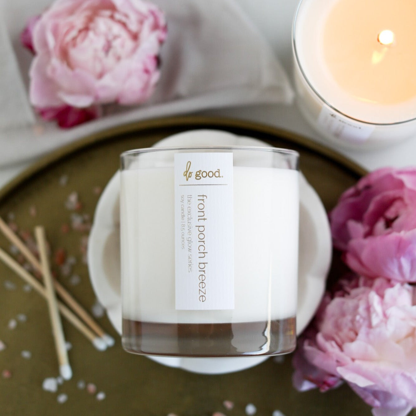 flatlay image of front porch breeze soy candle as a part of our Exclusive Glow series