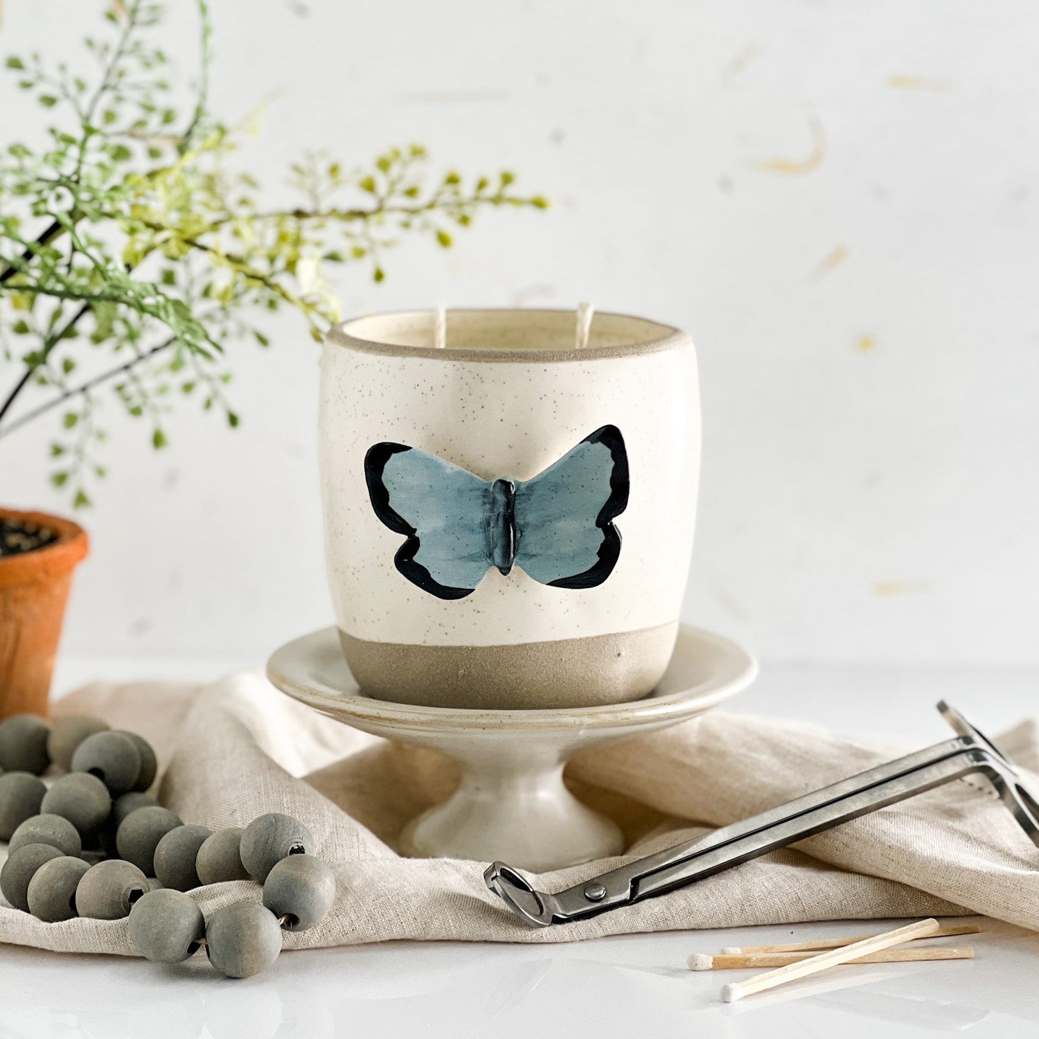 Image of one of our limited edition candles in a butterfly vessel