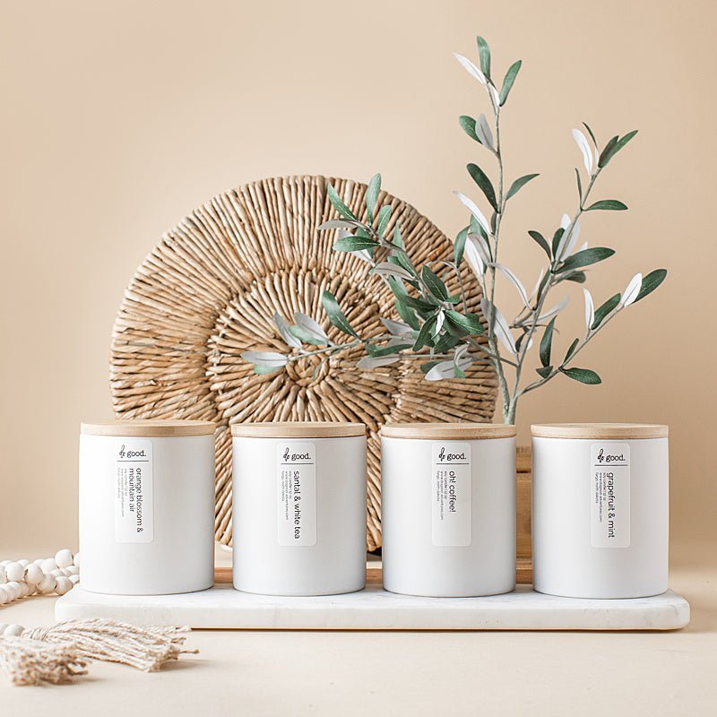 Image of four white signature soy candles in a row