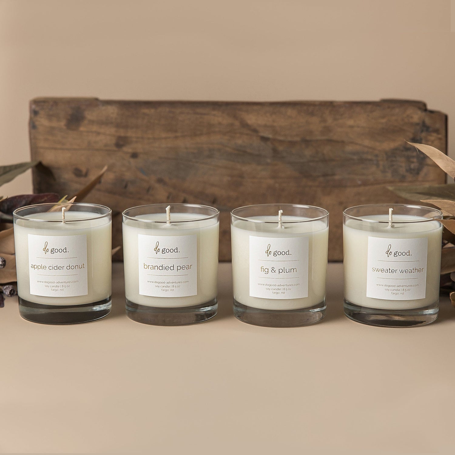 image of four soy candles in the winter/fall collection:  apple cider donut, brandied pear, fig & plum, and sweater weather