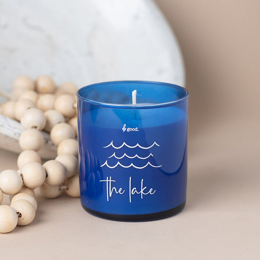 Lake season is the best season of the year!  The scent of this soy candle will bring back memories of amazing lake days and evenings and will elevate the summer days ahead.  This candle is poured in a sapphire blue straight-sided tumble and imprinted with waves and "the lake".  This 8.5-ounce soy candle has earthy notes of cedar, musk, and woody violet combined with lush florals, citrus, and eucalyptus.  All the scents of a summer day at the lake....and maybe an evening storm brewing in the distance.